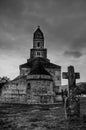 An old cross and Densus medieval church Saint Nicholas, a Dacian and Roman temple in Hunedoara, Hateg, Romania Royalty Free Stock Photo