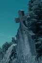 Old cross headstone on the graveyard