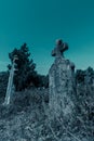 Old cross headstone on the graveyard