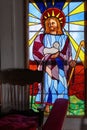 Old Crow, Canada. Colourful church window depicting Jesus Christ with a lamb in his arms.