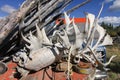 Canada. Wooden old table in the outside covered with caribou and moose antlers, pieces of junk and a car in the background.