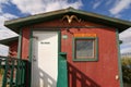 Old Crow, Yukon Territorry, Canada. Red house in the middle of town.