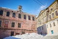 Old crumbling abandoned buildings in forgotten area of the city. Winter landscape