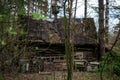 An old, crumbling abandoned house in the woods.an ancient, century-old house, living out its last years