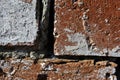 Old crumbling brick wall with shabby white paint, grunge texture background Royalty Free Stock Photo