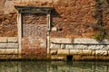 Venice, Italy. Old brick wall and canal waterfront Royalty Free Stock Photo