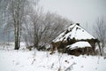 An old crumbling hut in the winter forest Royalty Free Stock Photo