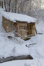 old, crumbling hut in a winter snow-covered forest Royalty Free Stock Photo