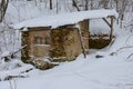 Old, crumbling hut in a winter snow-covered forest Royalty Free Stock Photo