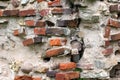 Old crumbling masonry wall with red bricks and stones.Old red brick wall, grunge background Royalty Free Stock Photo