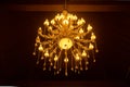 Old Crystal Chandelier on Ceiling with Warm Light Royalty Free Stock Photo