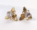 Old crystal vintage earrings on beige background, statement retro jewelry for women