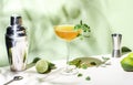 Old Cuban cocktail drink with white rum, lime juice, sparkling wine, syrup, bitter, mint and ice. Light green background, hard