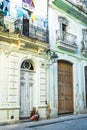 Old Cuban girl sitting looking at the street of the old havana