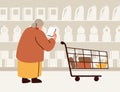 Old customer choosing product in supermarket. Senior elderly woman consumer shopping in hypermarket. Female shopper