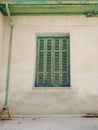 Old Cyprian window with green shutter and drainpipe. Royalty Free Stock Photo