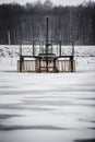 Old dam in frozen lake in winter Royalty Free Stock Photo