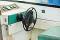 Old and damage steering wheel and dashboard of white speedboat. Royalty Free Stock Photo