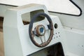 Old and damage steering wheel and dashboard of white speedboat Royalty Free Stock Photo