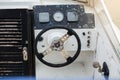 Old and damage steering wheel and dashboard of white speedboat. Royalty Free Stock Photo