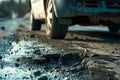 Old damaged asphalt pavement road with potholes in city. Car stopped near pothole on very poor quality street in evening Royalty Free Stock Photo