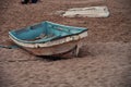Damaged boat abandoned on sandy beach Royalty Free Stock Photo