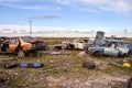 Old damaged cars in the junkyard. Car graveyard