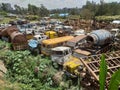 Old and damaged cars and machineries at a scrap yard