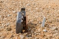 Old, damaged, discarded office chair buried under mud