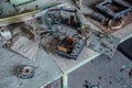 Old damaged dusty soviet electrical circuit boards on the table in abandoned factory of radio components