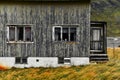 Old damaged facade of a wooden house in the village Vinstad at the coast on Lofoten Islands in Norway Royalty Free Stock Photo