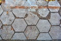 Old damaged hexagonal stone block pavement