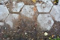 Old damaged hexagonal stone block pavement