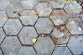 Old damaged hexagonal stone block pavement