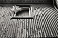 Old damaged house facade with window and curtain Royalty Free Stock Photo