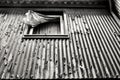 Old damaged house facade with window and curtain Royalty Free Stock Photo