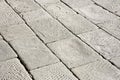 Old and damaged italian paving made with chiseled grey sandstone