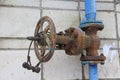 Old damaged and rusty iron oil pipe valve wheel. Metal, pipeline and mechanic concept. An old iron valve on a gas pipe. A valve to Royalty Free Stock Photo