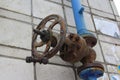 Old damaged and rusty iron oil pipe valve wheel. Metal, pipeline and mechanic concept. An old iron valve on a gas pipe. A valve to Royalty Free Stock Photo