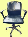 Old damaged used black dirty office chair officechair with rolling casters wheels and torne leather photo view image