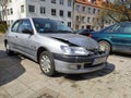 Wrecked damaged small car Peugeot 206 on street. Royalty Free Stock Photo