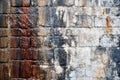 Old damp streaked stone wall with white and brown stained colours