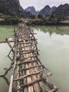 Old dangerous abandonned bamboo bridge crossing a river in the  Trung Khan District, Cao Bang Province, Vietnam Royalty Free Stock Photo