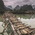 Old dangerous abandonned bamboo bridge crossing a river in the  Trung Khan District, Cao Bang Province, Vietnam Royalty Free Stock Photo