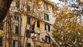 Old dangerous trees are being removed in cities. The process of sawing a tree trunk. A worker of a city municipal Royalty Free Stock Photo