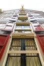 The old dark building. Housing with shutters. View from below. Windows with shutters Royalty Free Stock Photo