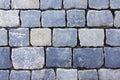 Old dark gray cobblestone pavement road from smooth stones as background top view closeup Royalty Free Stock Photo