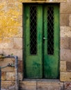 Old Dark green emerald metal dirt door with keyhole and rusty metal lockas a beautiful vintage background Royalty Free Stock Photo