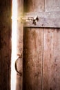 Old dark room with shining closed door. Royalty Free Stock Photo