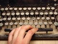 Old dark typewriter with hand